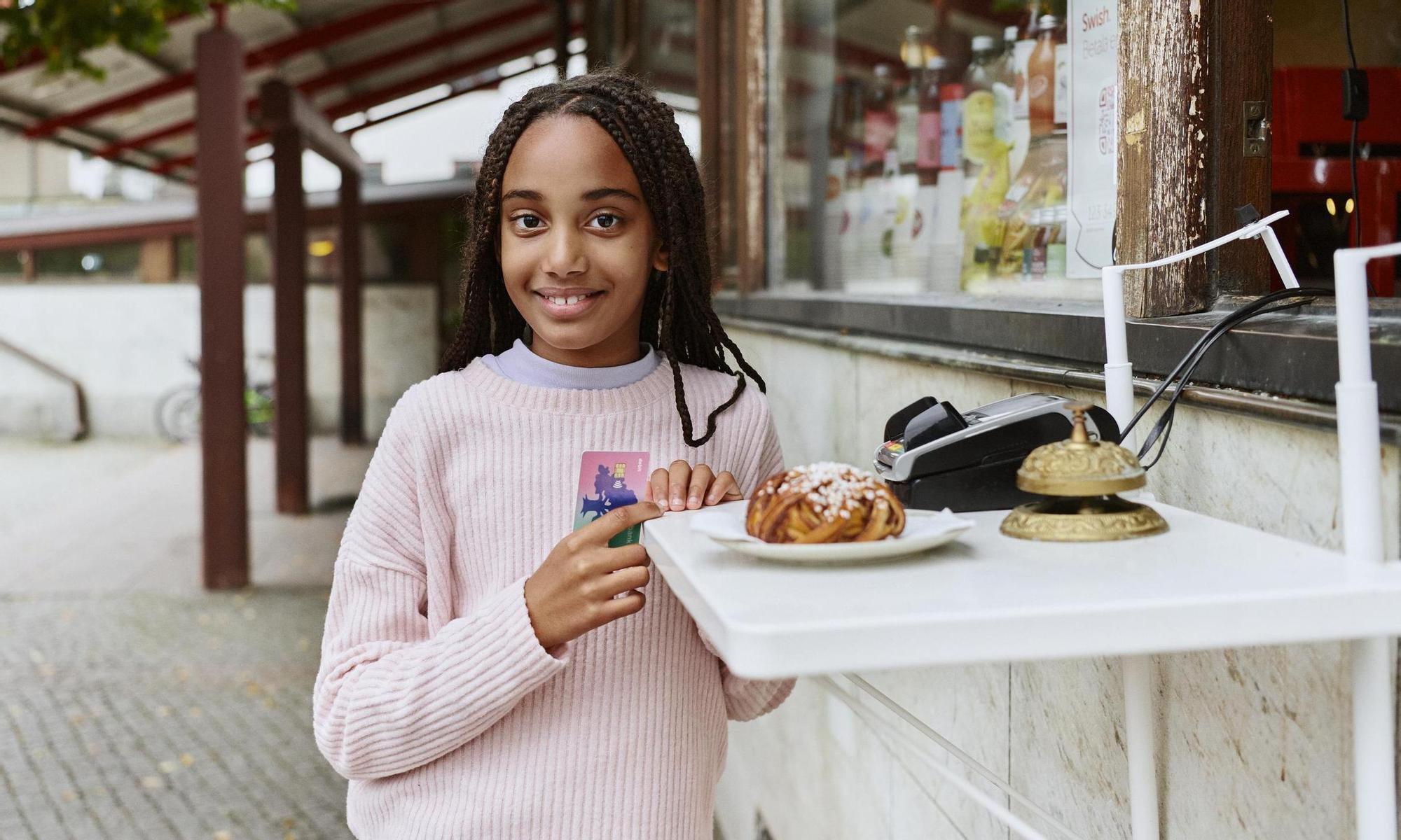 Girl pays for bun at a café