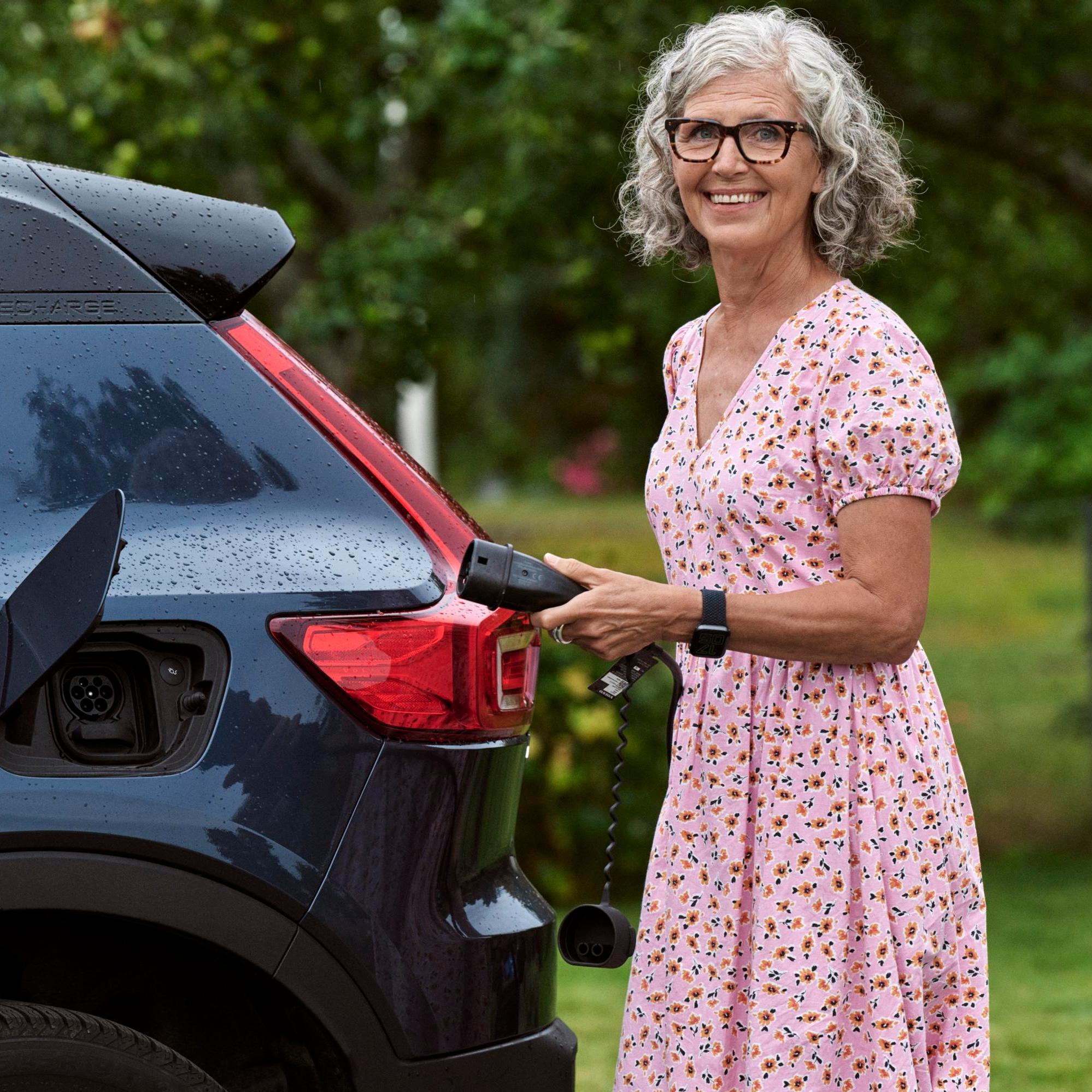 Woman charging electric car