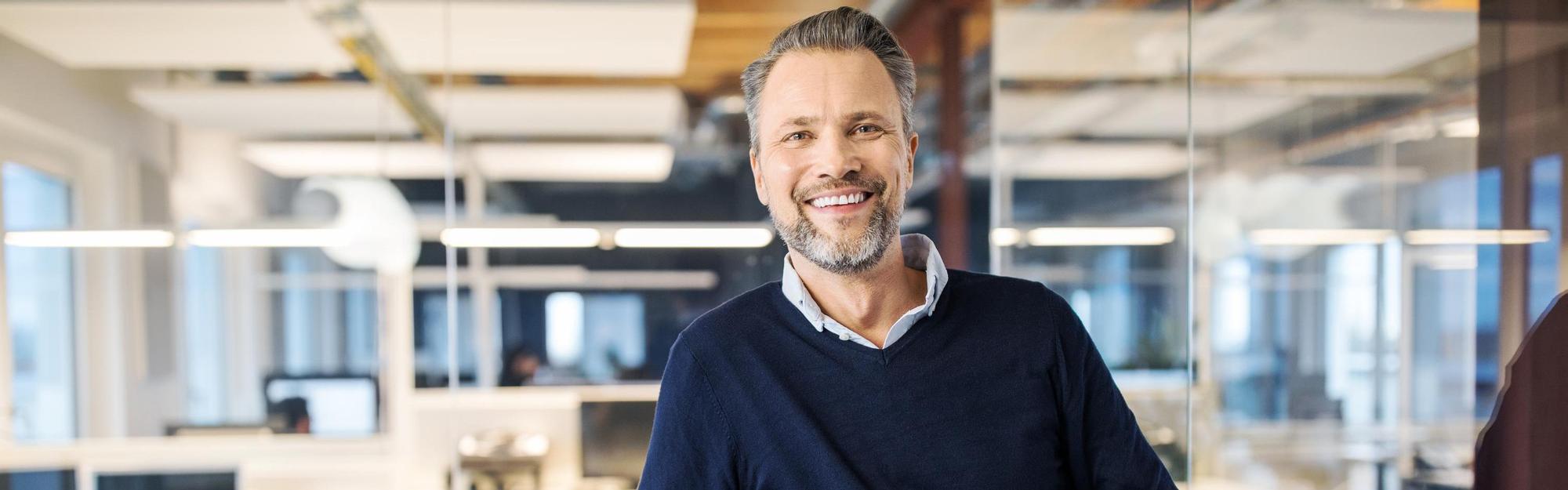 Mid adult businessman standing in office