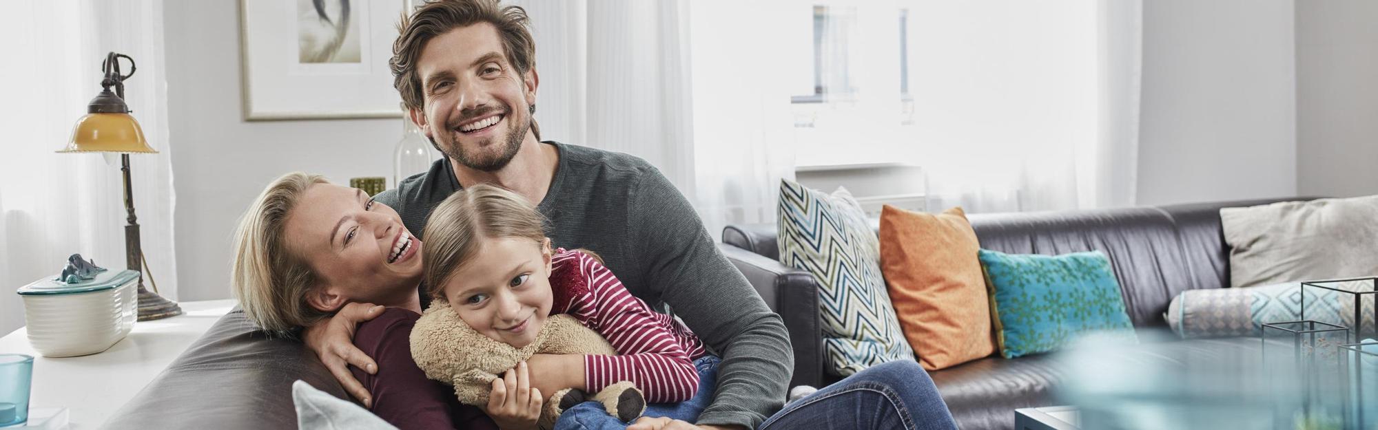 Happy family sitting on couch at home