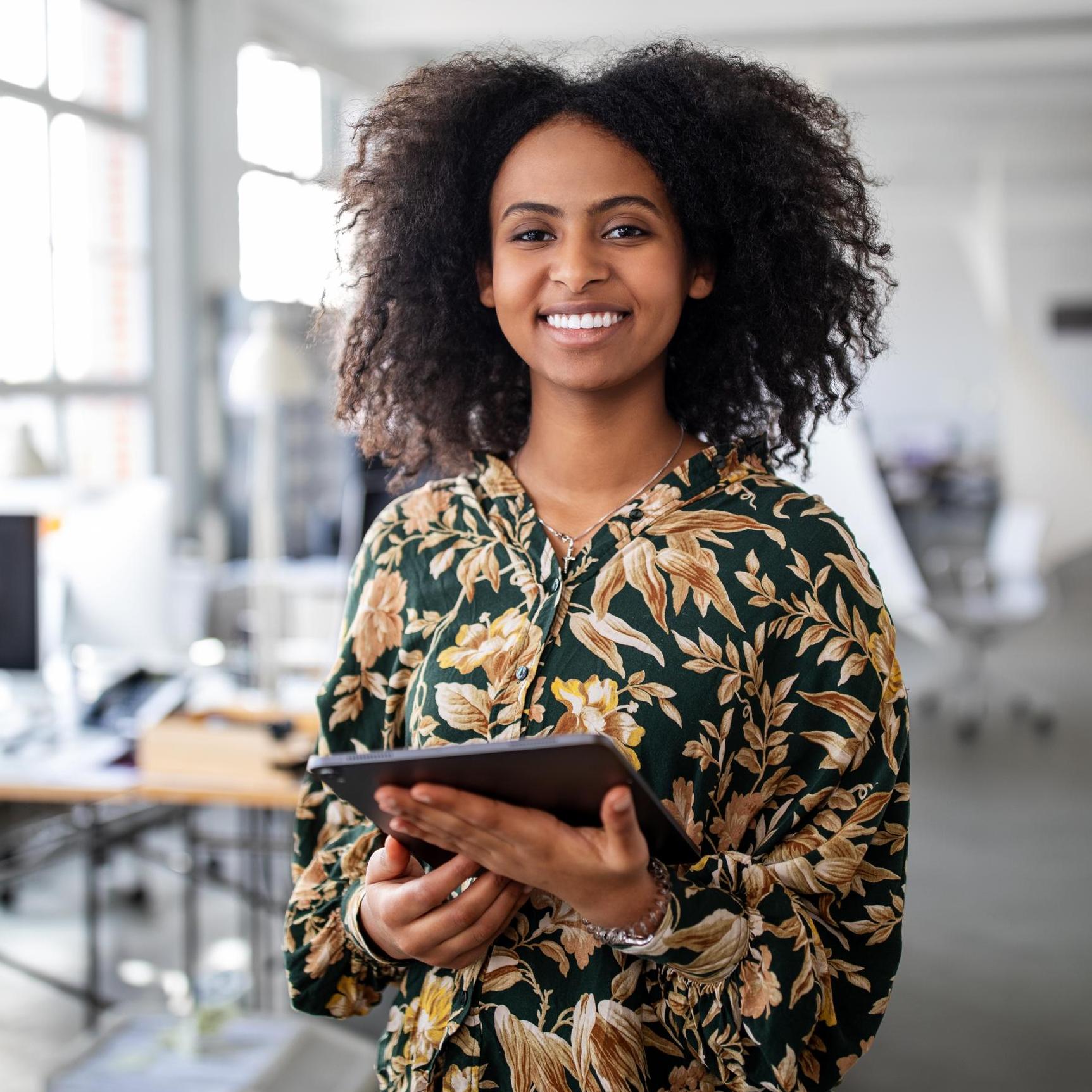 Woman standing with digital tablet in office